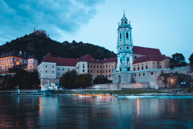 Wine tasting on traditional wooden boats in Wachau Valley - Dürnstein landmarks: castle, abbey, and ruins from the river